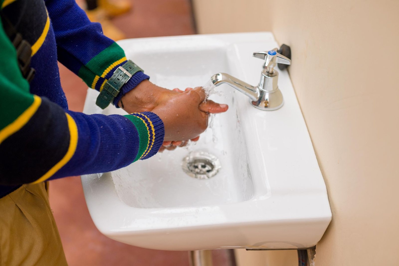 A pupil washing hands